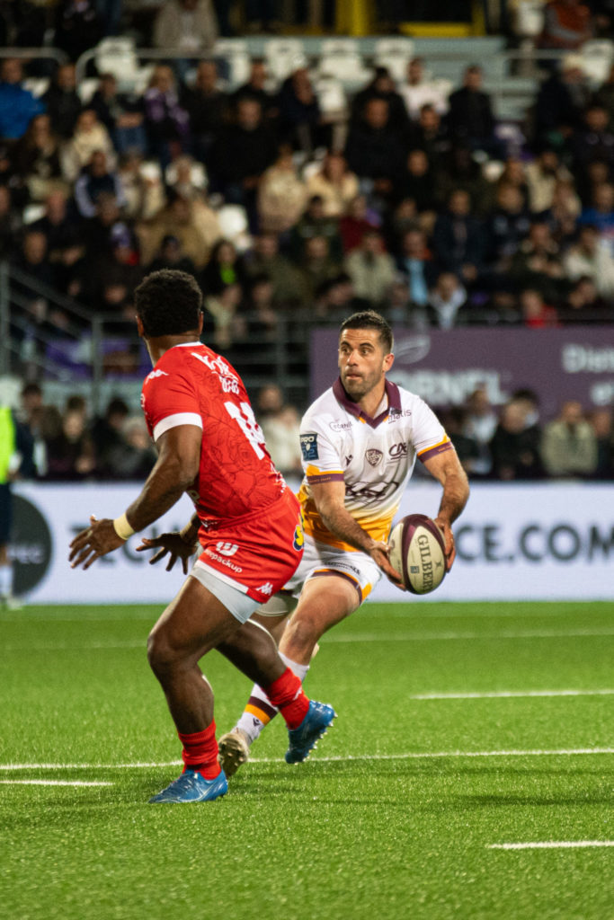 Joueur de rugby avec ballon en match.